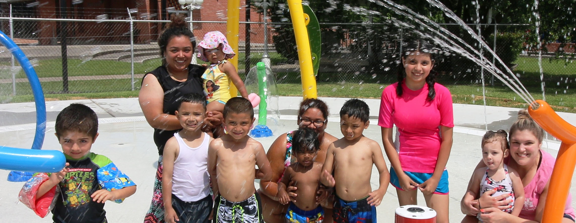 A splash pad from jacinto city with a crowd of people in front of it